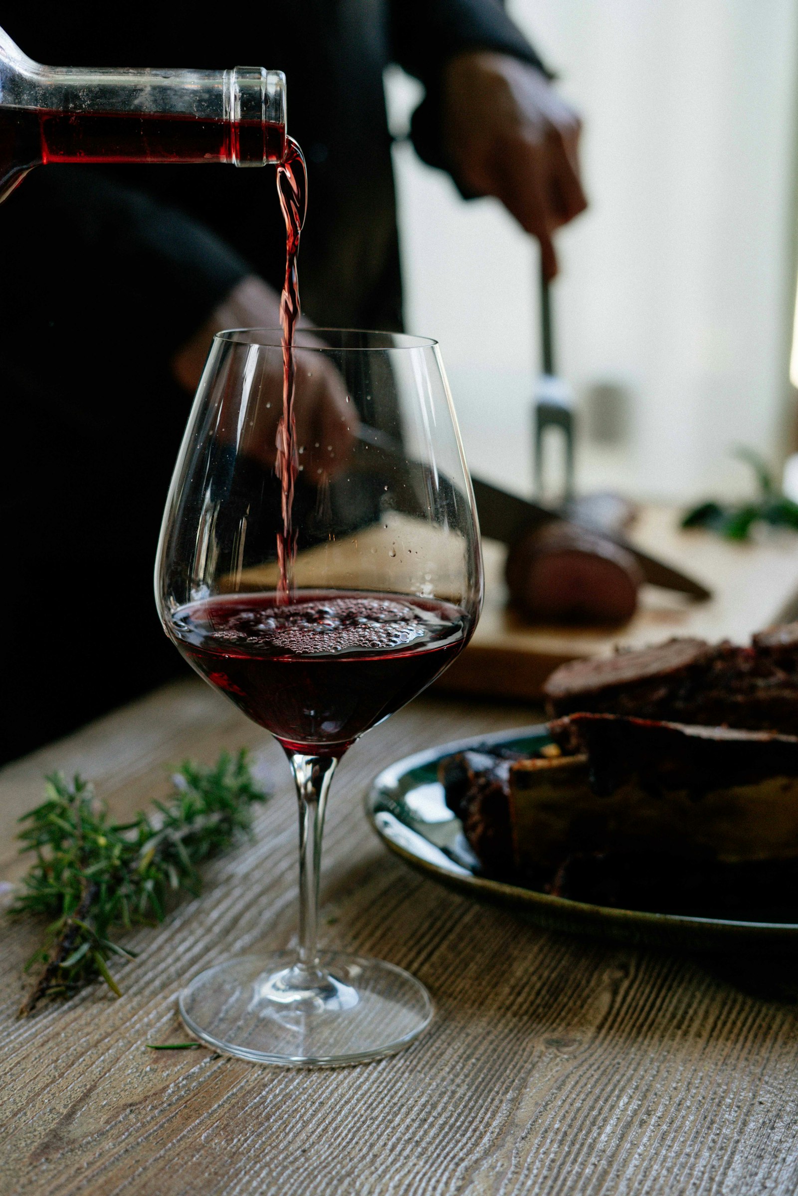 Vinho tinto sendo servido em taça de cristal
